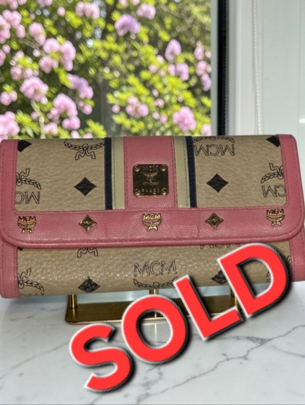 MCM Visetos Long Trifold Wallet with pink leather trim and gold-plated hardware